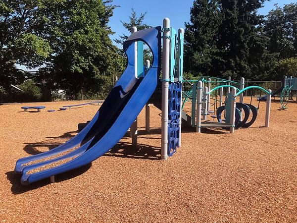 a slide connected to a climbing toy