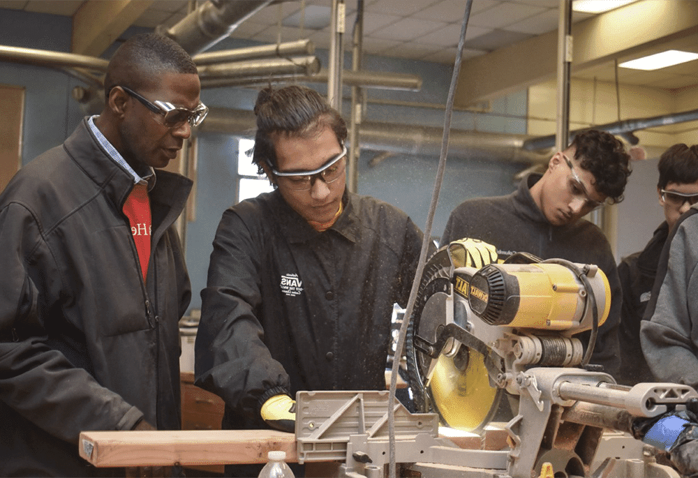 Students and a mentor working in a wood shop