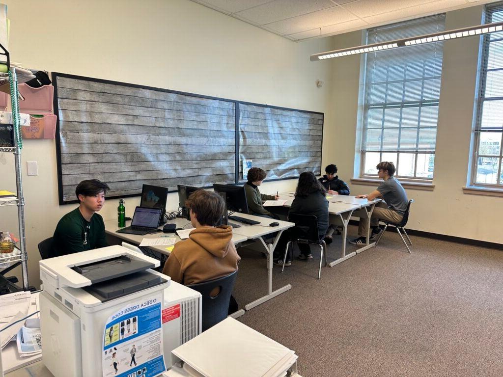 Students conducting mock interviews in classroom