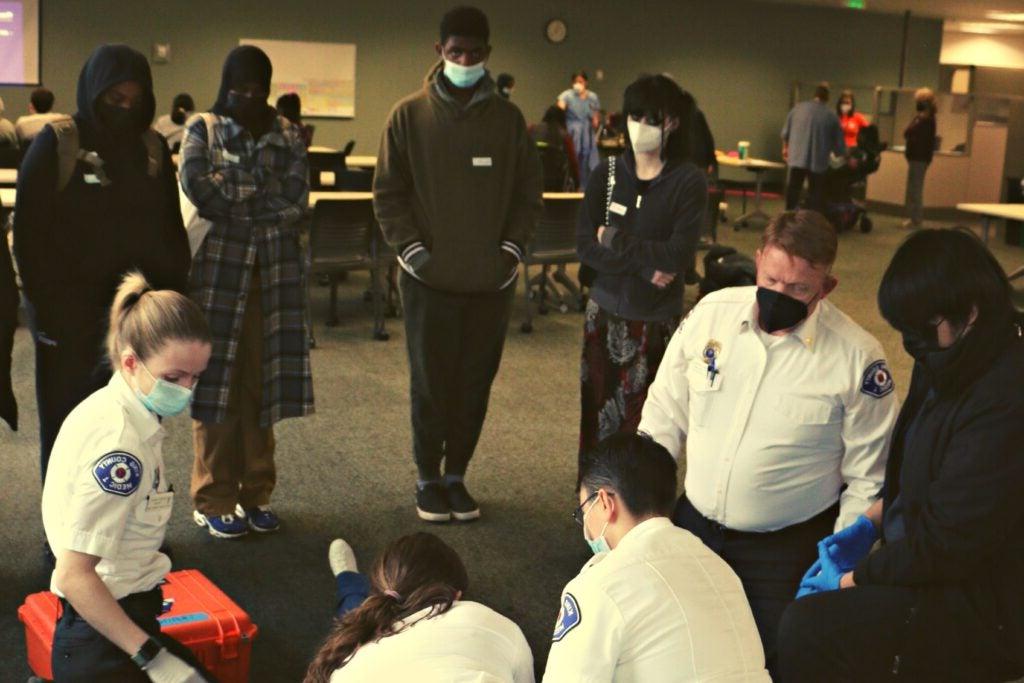 The HOSA (Health Occupation Students of America) clubs from Rainier Beach and Franklin High School visited Harborview's Injury Prevention Research Center where they learned more about injury and violence prevention careers. students observing a life saving scenario