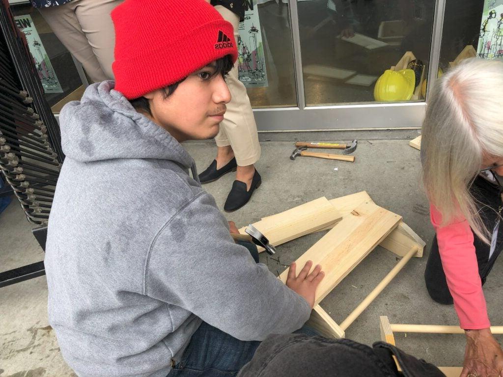 student working with wood and tools