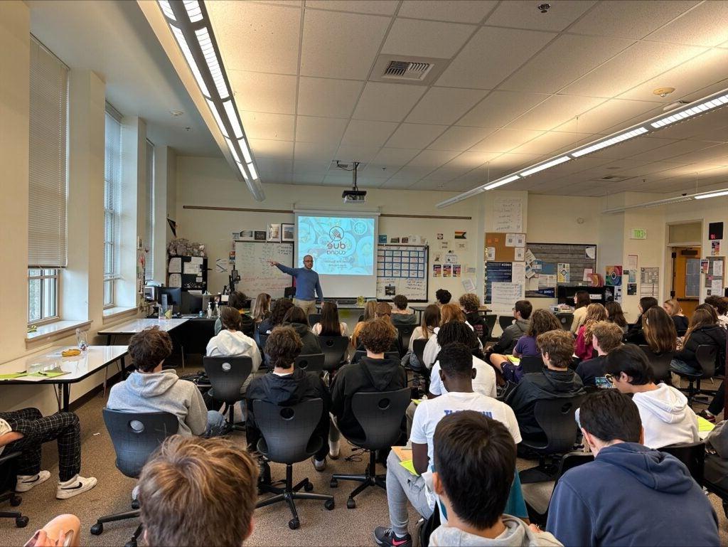 Students sit in class listening to guest lecturers at Roosevelt HS