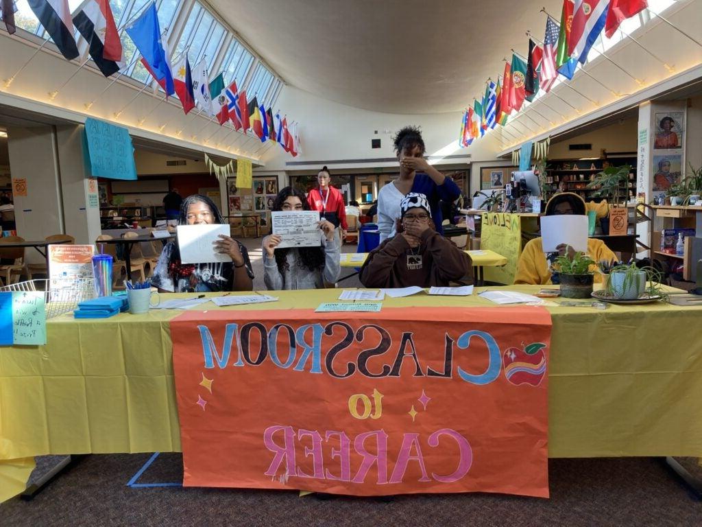 Student volunteers greet guest speakers and tablers