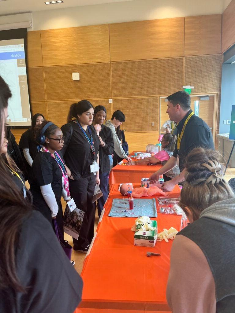 Students visiting  booths at health care career fair