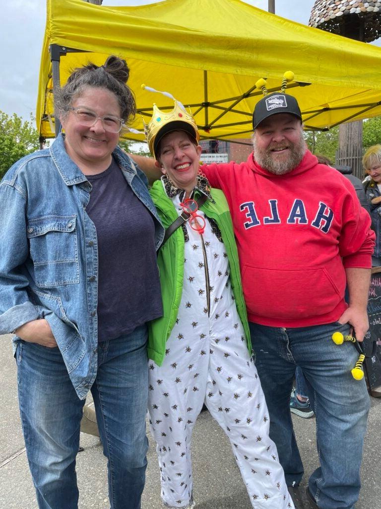 three people at the plant sale