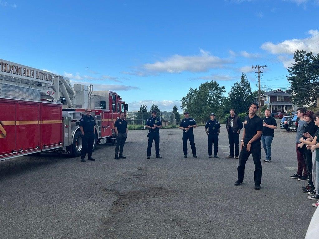 Firefighters next to firetruck